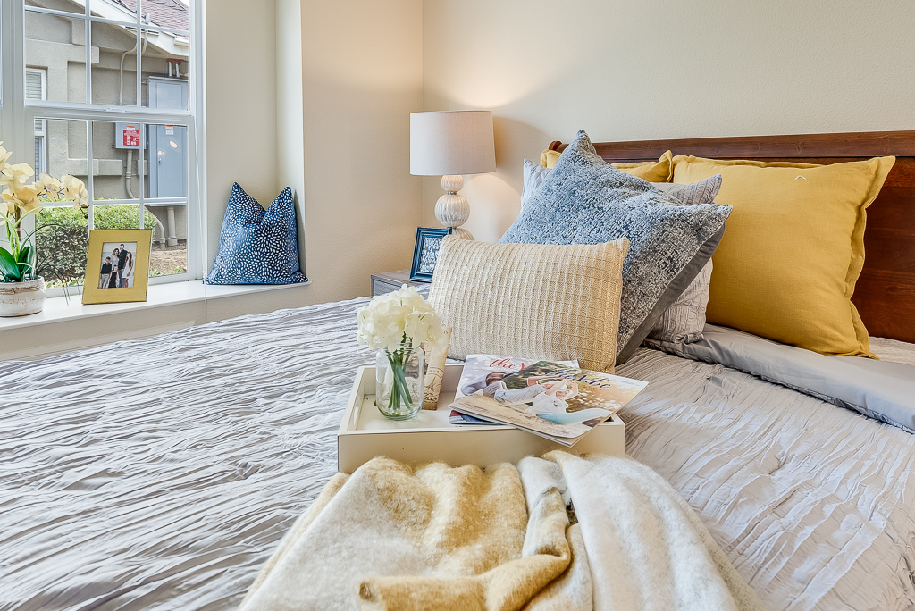 bed with pillows and a blanket